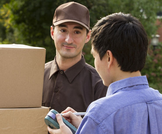 photo of a mover and a customer signing a finished move